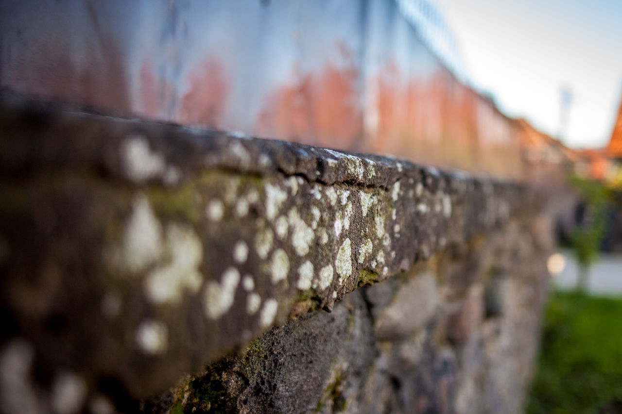 CLOSE-UP OF WATER DROP ON RETAINING WALL