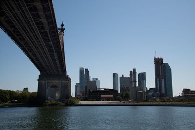 Buildings in city against clear sky