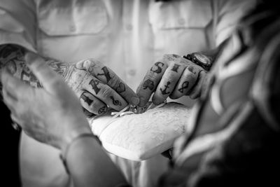 Close-up of couple with rings at home