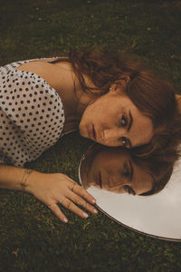 Portrait of woman with arms raised on field