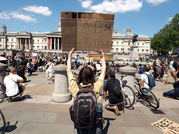 People on city street against sky