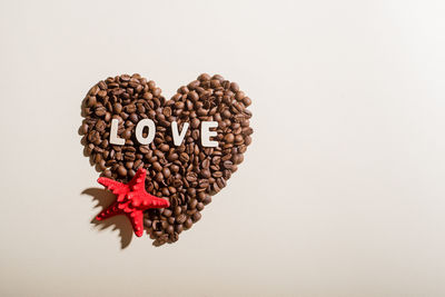 Close-up of heart shape made over white background