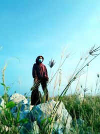 Man standing on field against clear sky