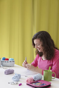 Woman sitting on table at home