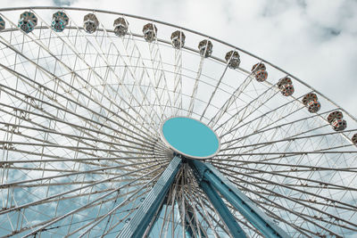 Low angle view of ferris wheel against sky