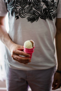 Midsection of woman holding ice cream