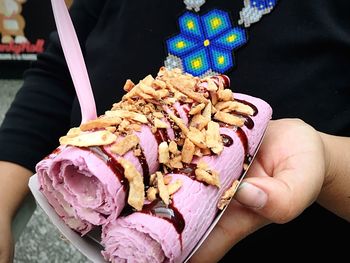 Close-up of hand holding ice cream