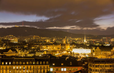 High angle view of illuminated buildings against sky at night