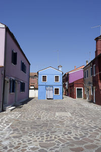 Residential buildings against clear blue sky