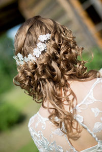 Rear view of bride with wearing artificial flowers in hair