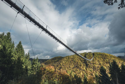 Low angle view of bridge over mountain against sky