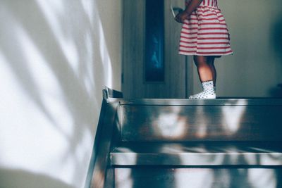 Low section of girl standing on floor