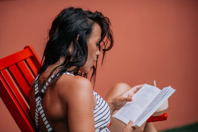 Midsection of woman holding umbrella