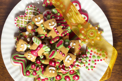 Directly above shot of colorful christmas cookies in plate on table