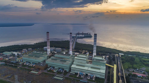 High angle view of factory against sky during sunset