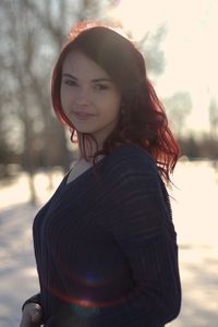 Portrait of smiling young woman standing outdoors