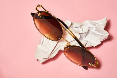 Close-up of sunglasses on table against white background