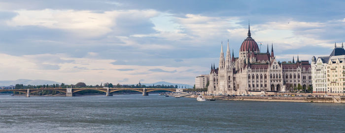 View of bridge over river against cloudy sky