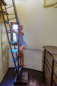 Portrait of woman on staircase against building