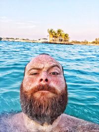 Portrait of man in sea against sky