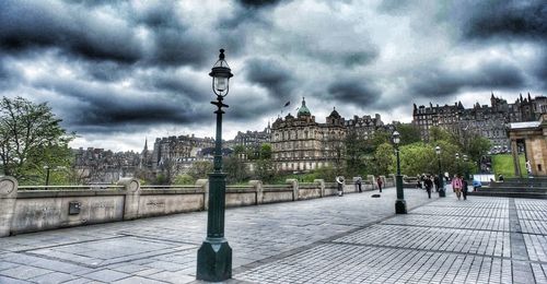 Buildings in city against cloudy sky