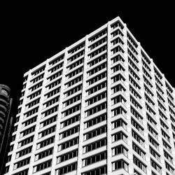 Low angle view of modern buildings in city at night