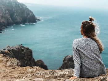 Rear view of woman looking at sea against sky