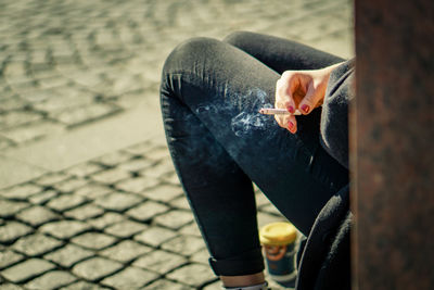 Woman smoking on street