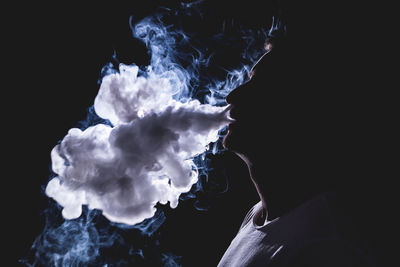 Close-up of smoke emitting from black background