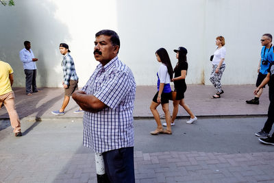 People standing on mask against sky