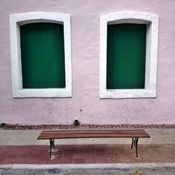 Empty bench by wall