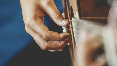 Close-up of man playing guitar