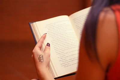 Cropped image of woman reading book