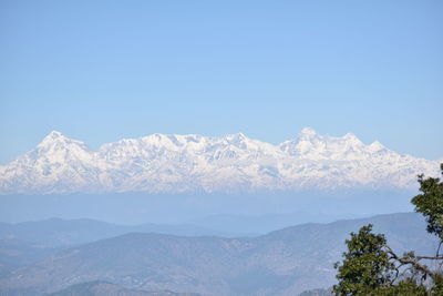 Scenic view of snowcapped mountains against clear sky