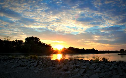 Scenic view of beach against sky during sunset