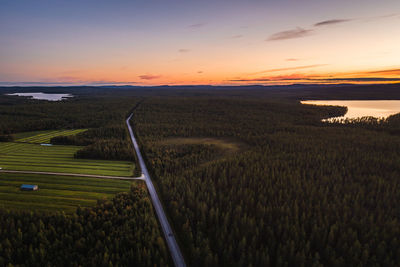 Scenic view of agricultural field against sky during sunset