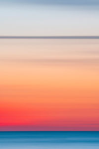 Long exposure, motion blur shot of the sun setting above the baltic sea.