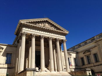 Low angle view of cour dappel de montpellier against clear blue sky