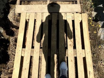 Low section of person standing on tiled floor