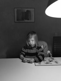 Portrait of smiling girl on table at home