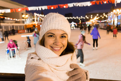 Portrait of smiling young woman in park during winter