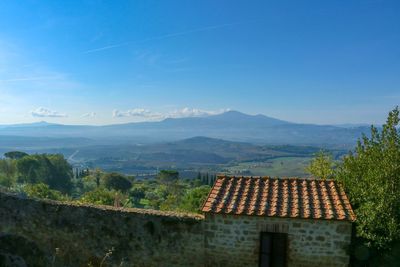 Scenic view of mountains against blue sky