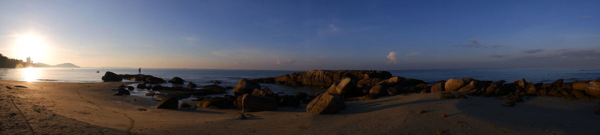 Panoramic view of beach against sky during sunset