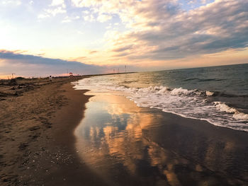 Scenic view of beach against sky during sunset