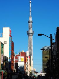 Modern buildings in city against clear blue sky