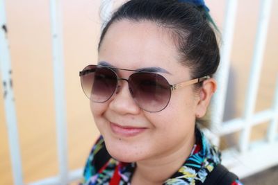 Portrait of smiling woman wearing sunglasses