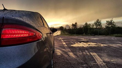 Cars on road at sunset