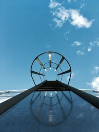 Low angle view of ladder against blue sky