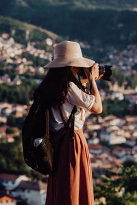 Midsection of woman wearing hat