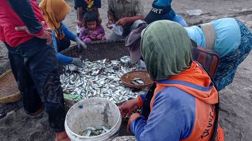 High angle view of people working at fish